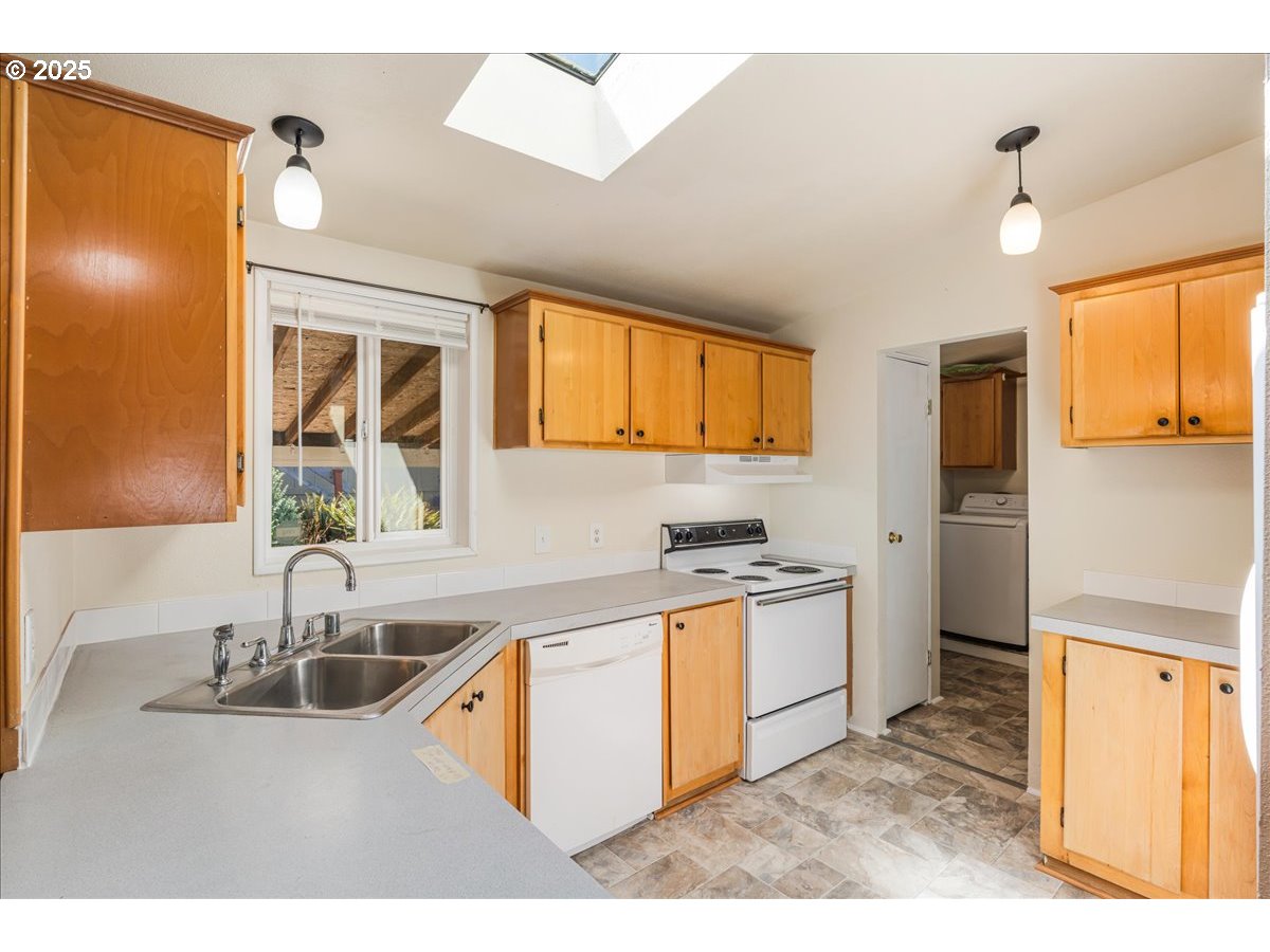 1819 Southeast Orient Drive, Unit 1 Gresham, OR 97080 - Photo 11 of 31 a kitchen with stainless steel appliances granite countertop a sink stove and refrigerator