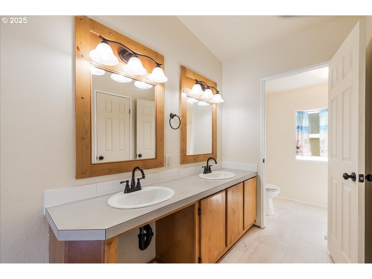 1819 Southeast Orient Drive, Unit 1 Gresham, OR 97080 - Photo 17 of 31 a bathroom with a sink and a mirror
