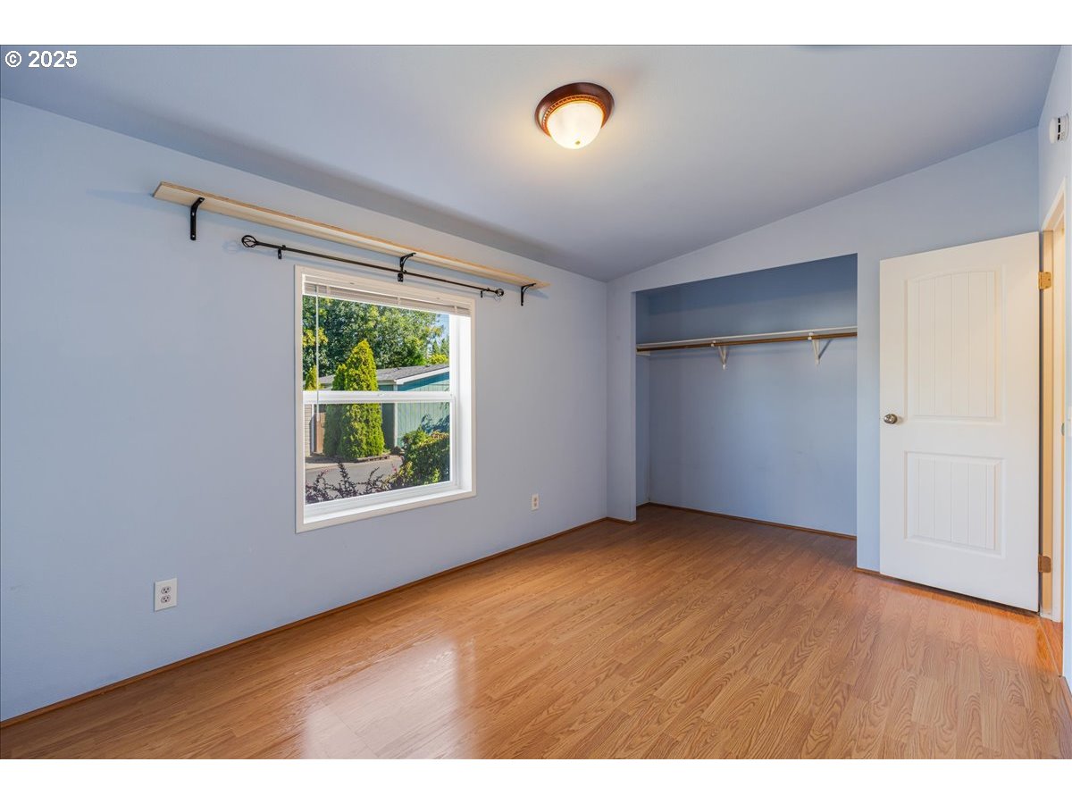 1819 Southeast Orient Drive, Unit 1 Gresham, OR 97080 - Photo 22 of 31 a view of an empty room with wooden floor and a window