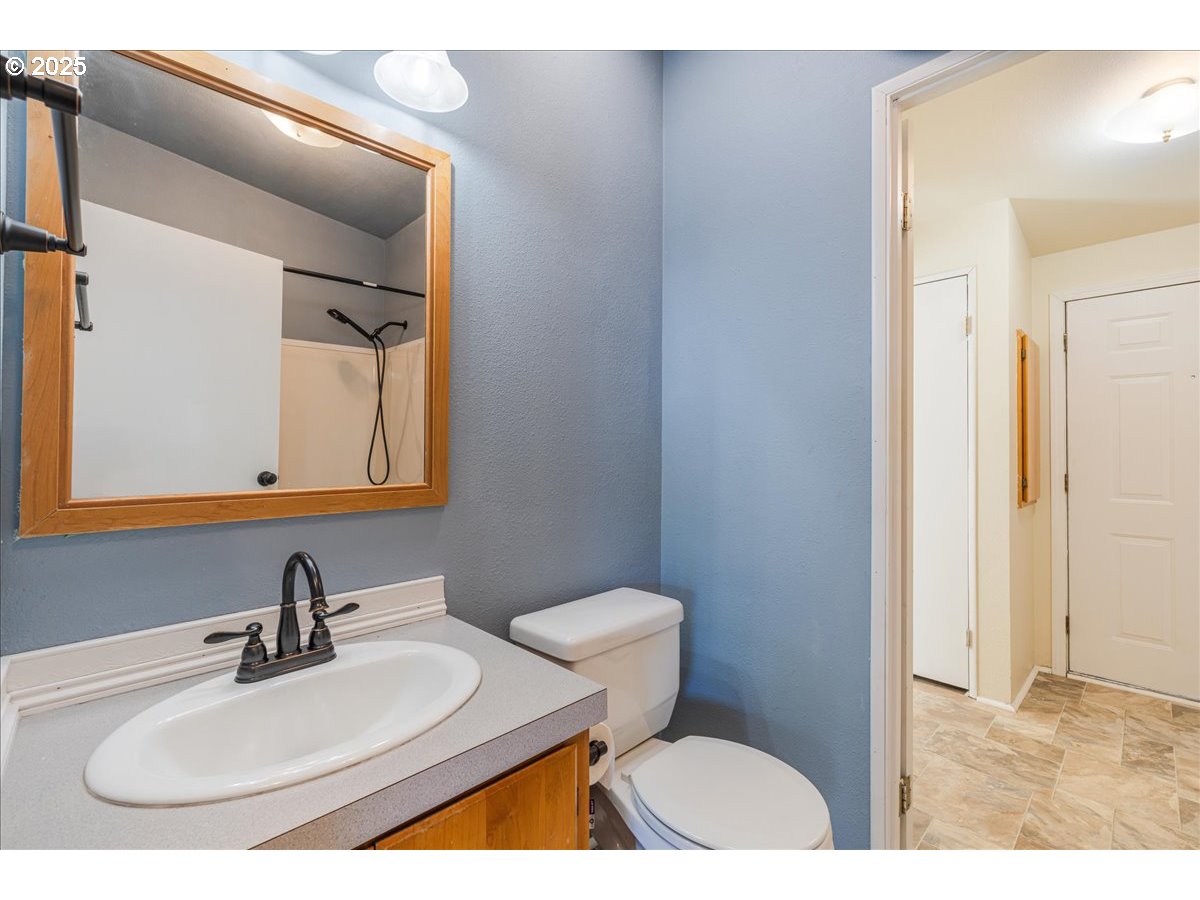 1819 Southeast Orient Drive, Unit 1 Gresham, OR 97080 - Photo 26 of 31 a bathroom with a sink and a mirror