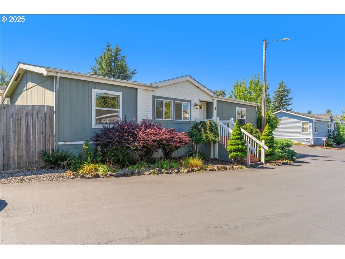 1819 Southeast Orient Drive, Unit 1 Gresham, OR 97080 - Photo 3 of 31 a front view of a house with a yard