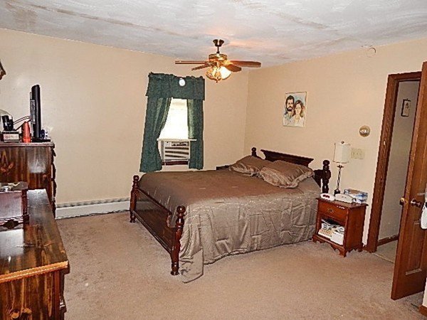 12 Gerard Avenue Freetown, MA 02717 - Photo 21 of 30 a spacious bedroom with a bed and a chandelier
