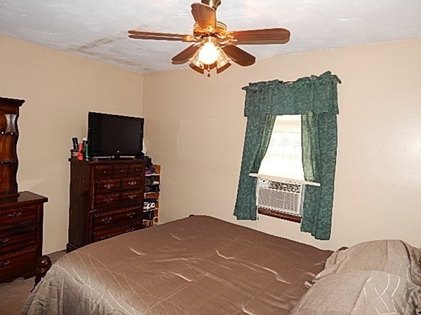 12 Gerard Avenue Freetown, MA 02717 - Photo 22 of 30 a bedroom with a bed and a flat tv screen on dresser