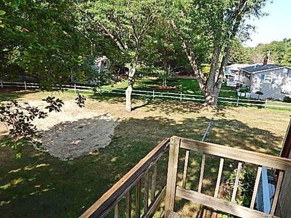12 Gerard Avenue Freetown, MA 02717 - Photo 9 of 30 a view of balcony with two trees and wooden fence