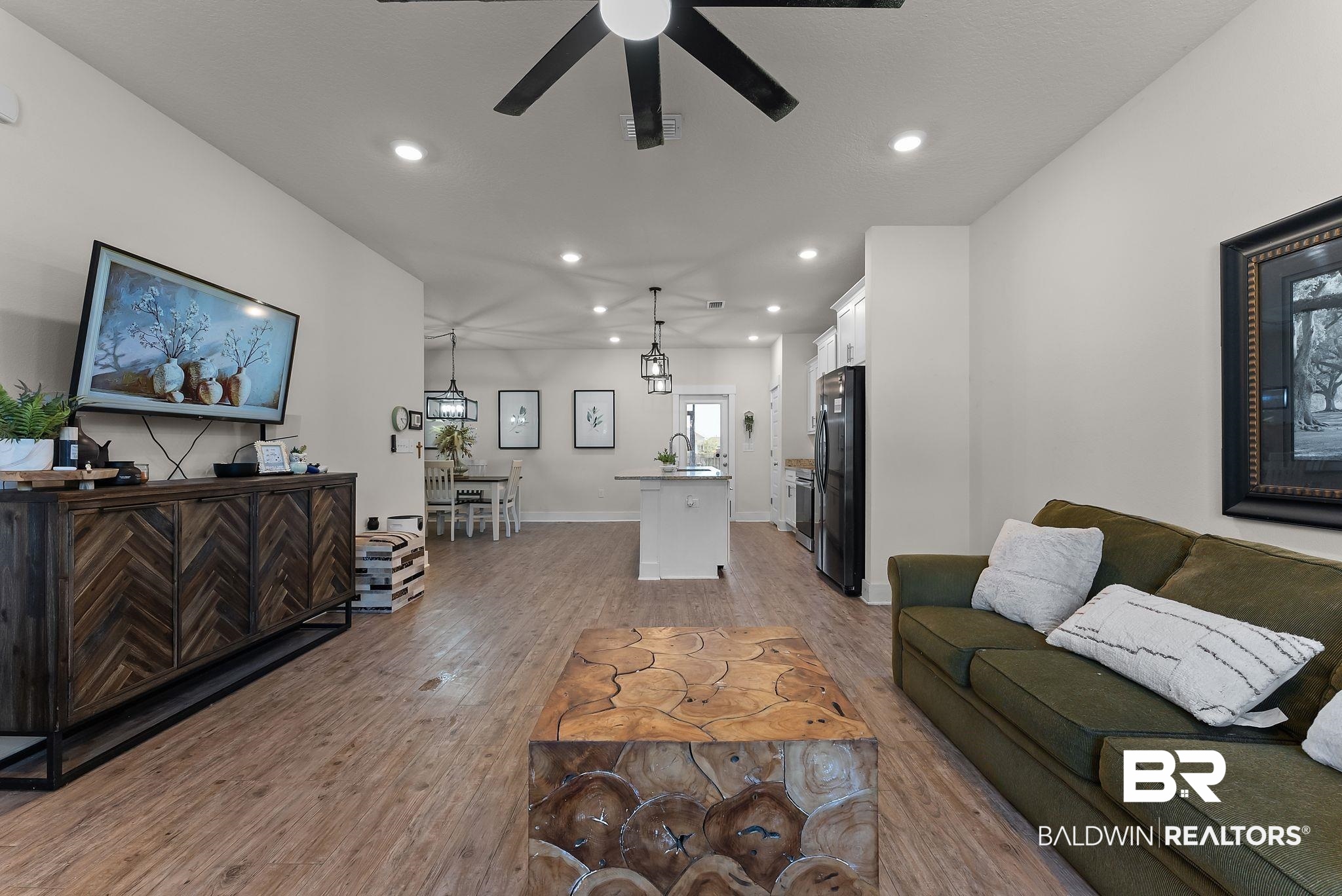 16607 Prado Loop Loxley, AL 36551 - Photo 8 of 46 Open-concept living space featuring wood-finish flooring, recessed lighting, and a ceiling fan