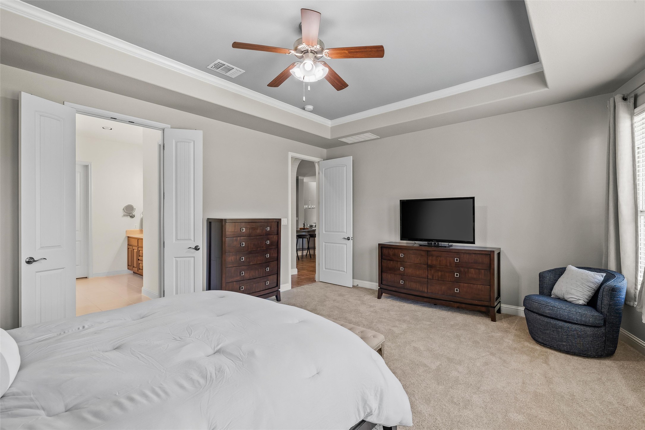 151 Swallowtail Drive Austin, TX 78737 - Photo 14 of 40 a bedroom with a bed a couch and a flat screen tv