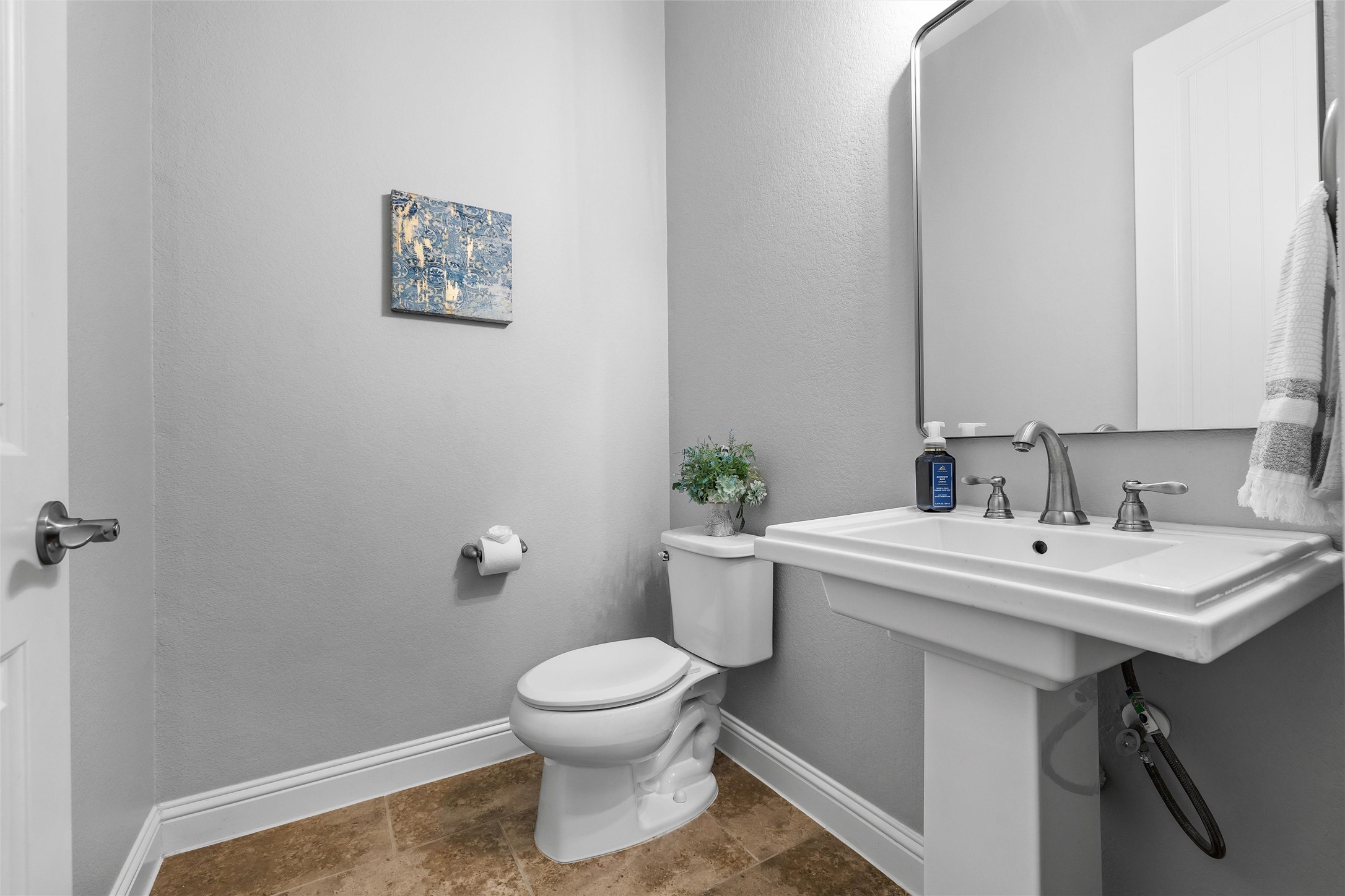 151 Swallowtail Drive Austin, TX 78737 - Photo 18 of 40 a white toilet sitting next to a bathroom sink