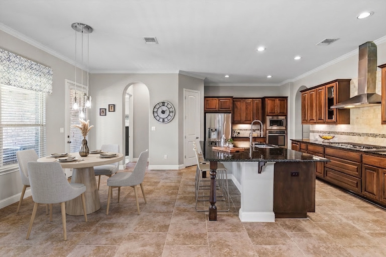 151 Swallowtail Drive Austin, TX 78737 - Photo 8 of 40 a kitchen with stainless steel appliances kitchen island granite countertop a table and chairs in it