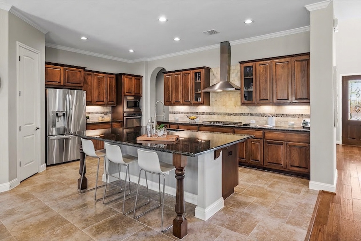 151 Swallowtail Drive Austin, TX 78737 - Photo 9 of 40 a kitchen with stainless steel appliances granite countertop a stove top oven a sink refrigerator and cabinets