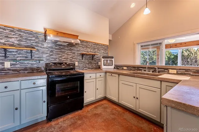 a kitchen with white cabinets and sink