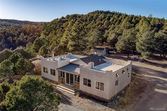 an aerial view of a house with a yard