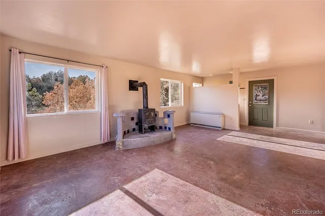 a view of a livingroom with furniture and a flat screen tv