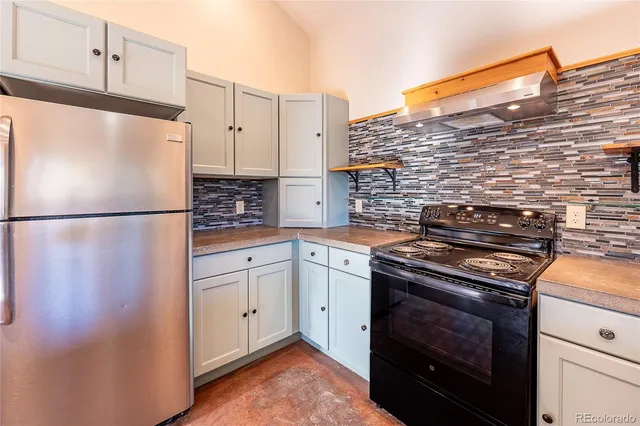 a kitchen with stainless steel appliances granite countertop a stove and a sink