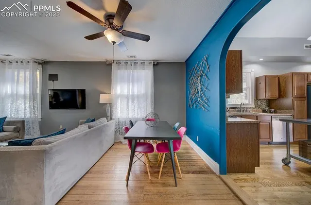 a living room with kitchen island furniture and a flat screen tv