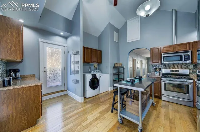 a kitchen with microwave a stove and cabinets