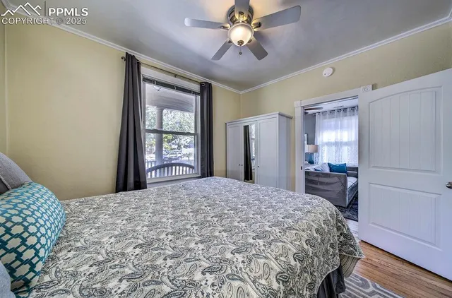 a bedroom with a large bed closet and window