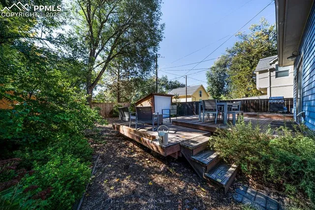 a view of house with yard and sitting area