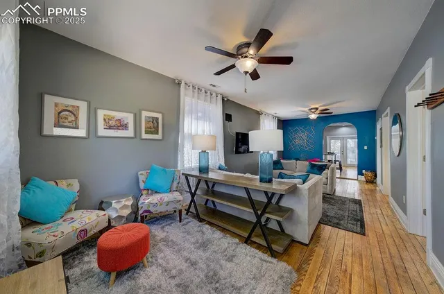 a living room with furniture and a wooden floor
