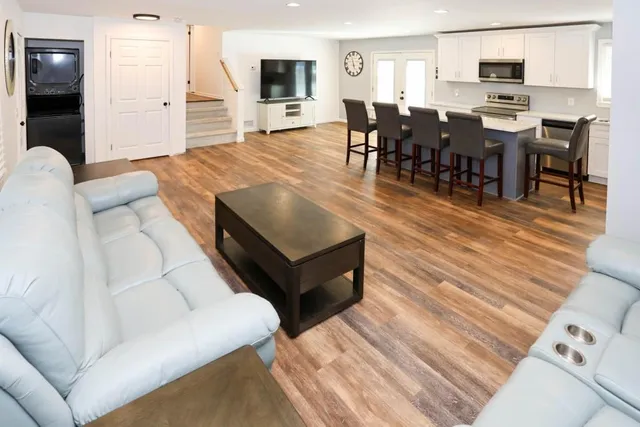 a living room with stainless steel appliances kitchen island granite countertop furniture and a kitchen view