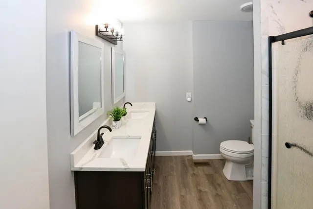 a bathroom with a sink toilet and a mirror
