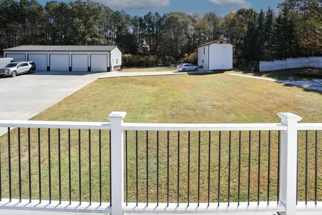 a view of a balcony with wooden floor and fence