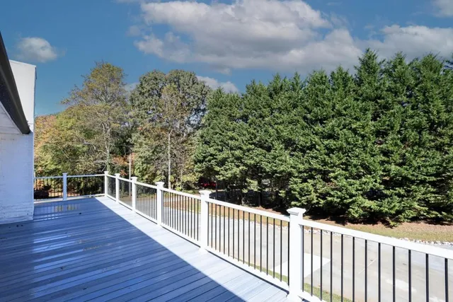 a view of a white house with a yard