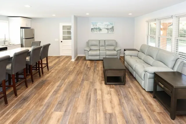 a living room with furniture and a wooden floor