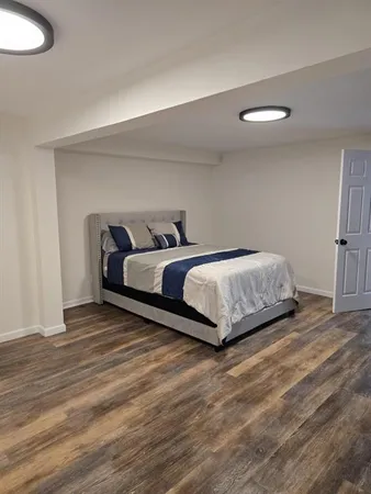 a bedroom with a bed and a television