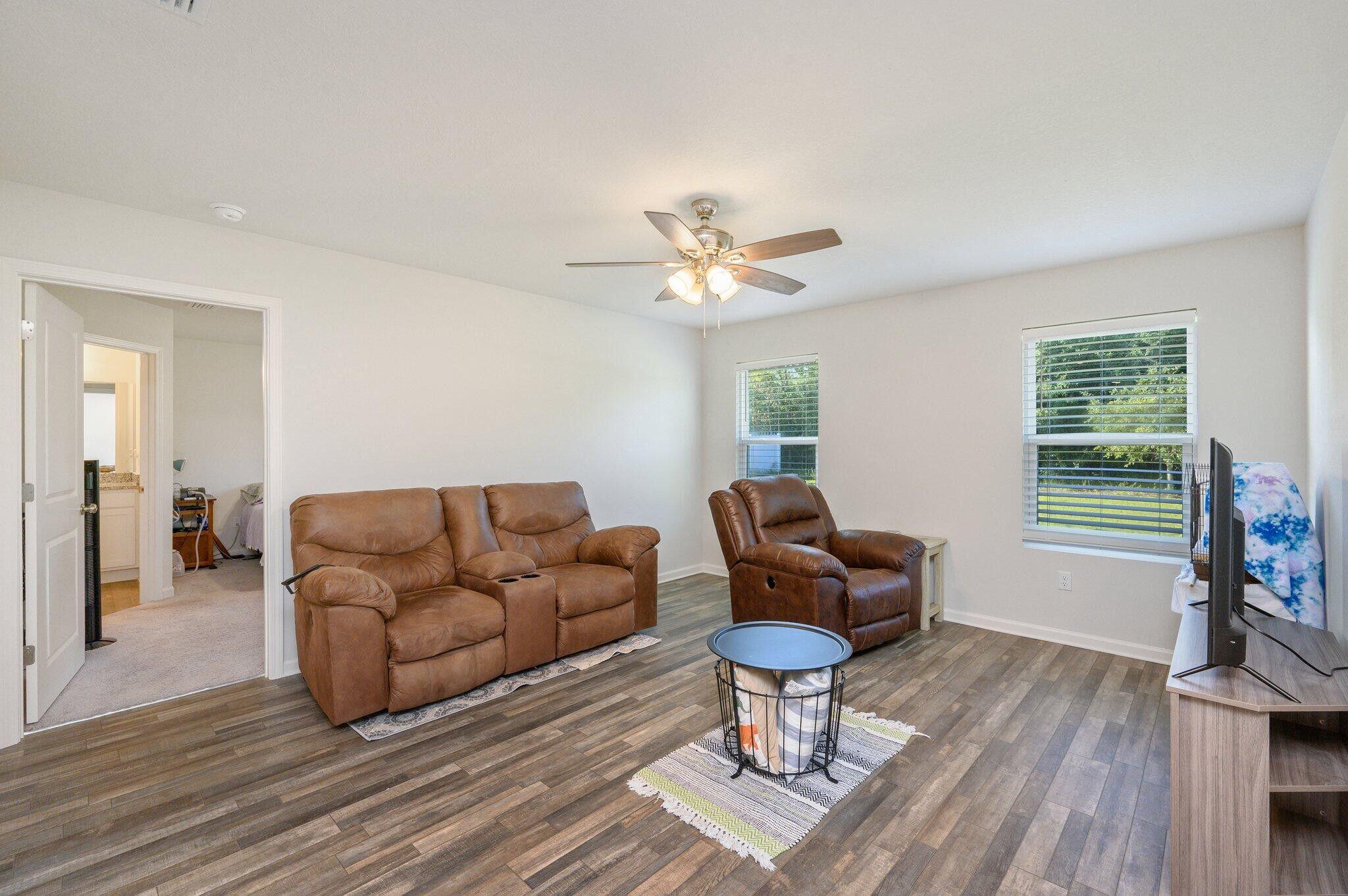 42 Lockwood Way East DeFuniak Springs, FL 32435 - Photo 13 of 38 a living room with furniture a fireplace and a flat screen tv