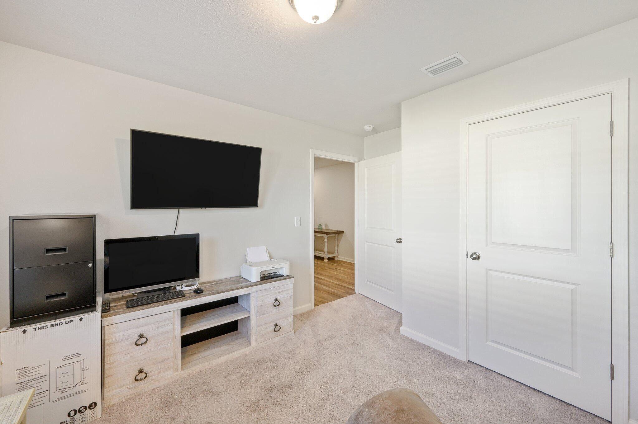 42 Lockwood Way East DeFuniak Springs, FL 32435 - Photo 22 of 38 a living room with furniture and a flat screen tv