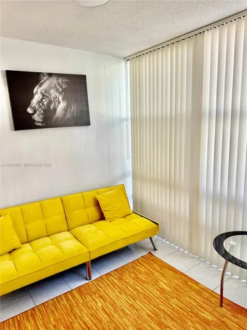 a blue couch sitting on top of a wooden floor