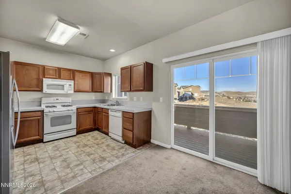 a large kitchen with stainless steel appliances granite countertop a stove refrigerator sink and cabinets