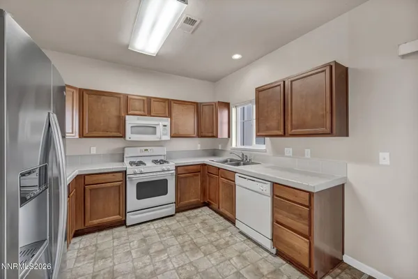 a kitchen with stainless steel appliances granite countertop a stove sink and cabinets