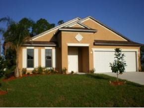 857 Northwest Rostock Palm Bay, FL 32907 - Photo 3 of 3 a front view of a house with a yard