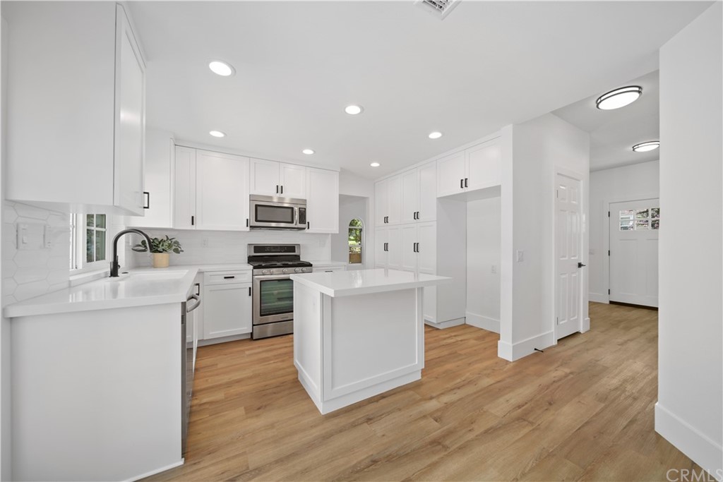 1641 Weathersfield Lane Riverside, CA 92506 - Photo 1 of 1 a kitchen with white cabinets and stainless steel appliances