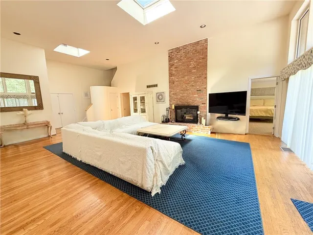 a spacious bedroom with a bed and a flat screen tv