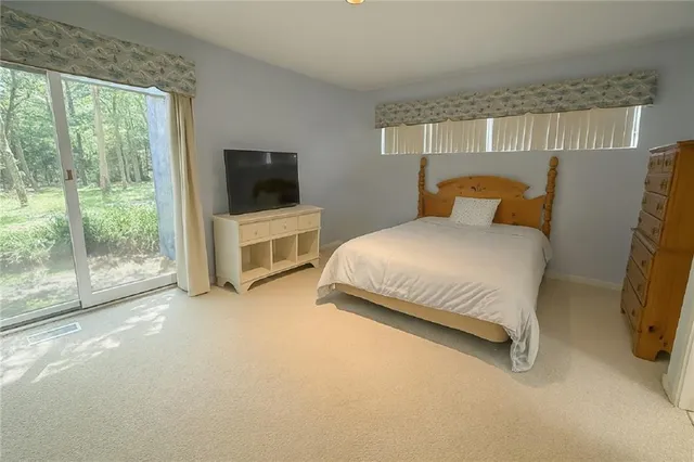 a bedroom with a bed and large window