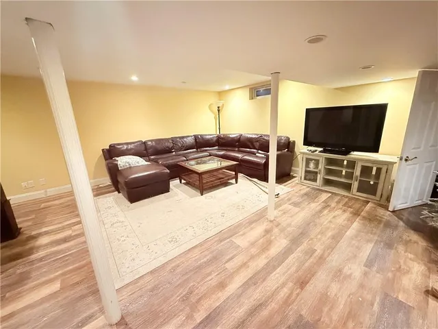 a spacious bedroom with a bed and chair in it