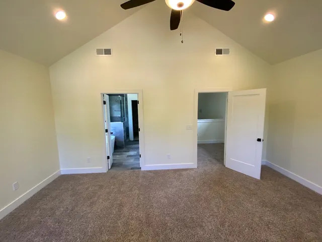 a view of empty room with ceiling fan