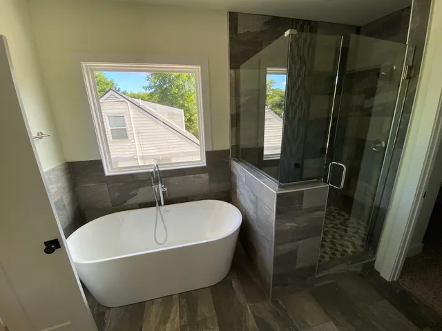 a bathroom with a bathtub and a shower