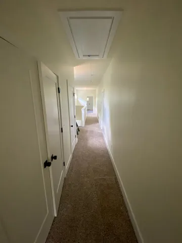 a view of a hallway with a white walls