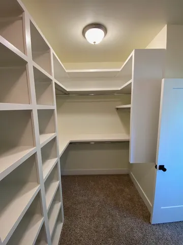 a view of an empty room with empty shelves