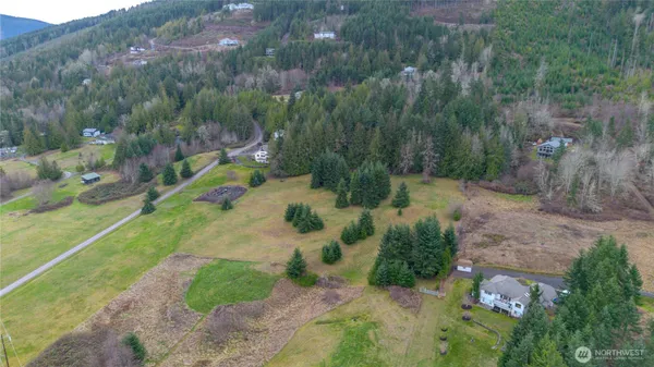 a backyard of a house with a yard and outdoor seating