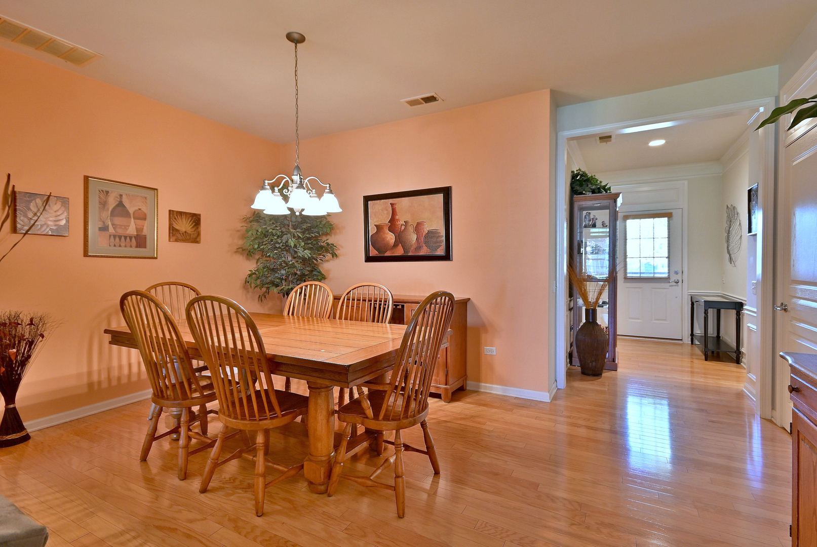 2832 Beacon Point Circle Elgin, IL 60124 - Photo 12 of 36 a dining room with furniture a chandelier and wooden floor