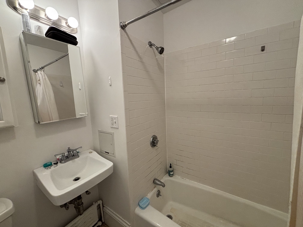 98 Charles Street, Unit 1 Boston, MA 02114 - Photo 7 of 9 a bathroom with a sink a toilet and shower