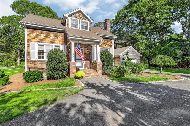a view of a house with a backyard and porch
