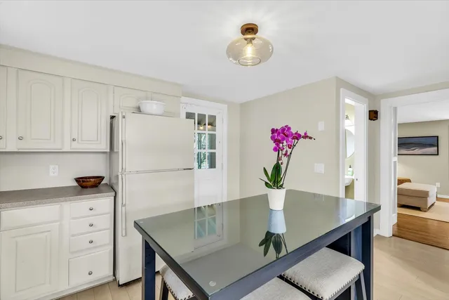 a view of kitchen with cabinets table and chair