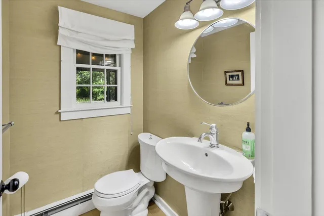 a bathroom with a sink a mirror and a toilet