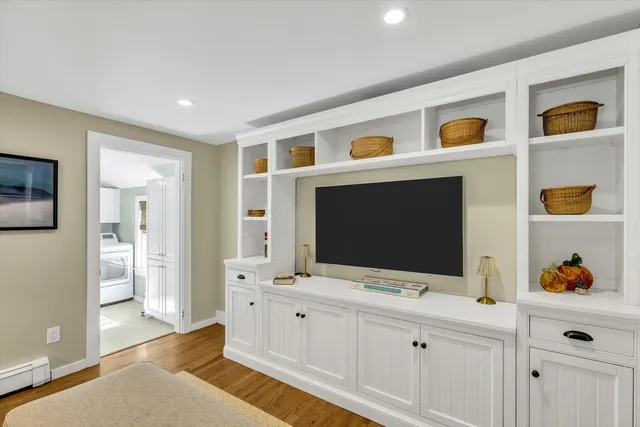 a living room with window and flat screen tv