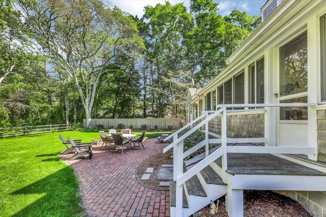 a view of a house with backyard and sitting area
